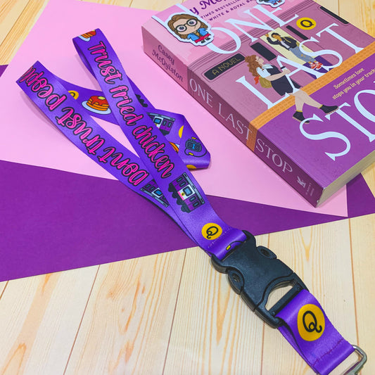 A lanyard featuring designs inspired by One Last Stop, with elements like subways, coffee cups, and romantic details.