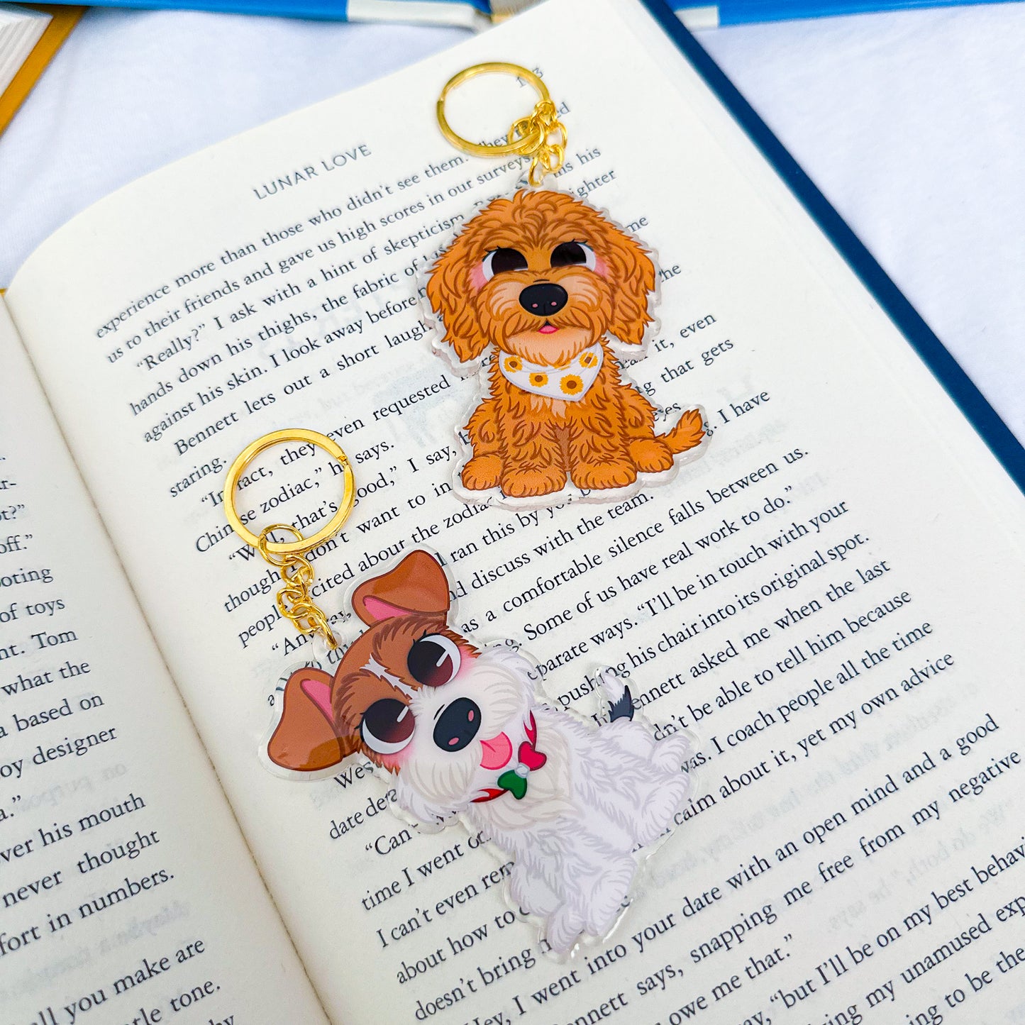 A keychain featuring two illustrated puppies, designed with playful and heartwarming details.