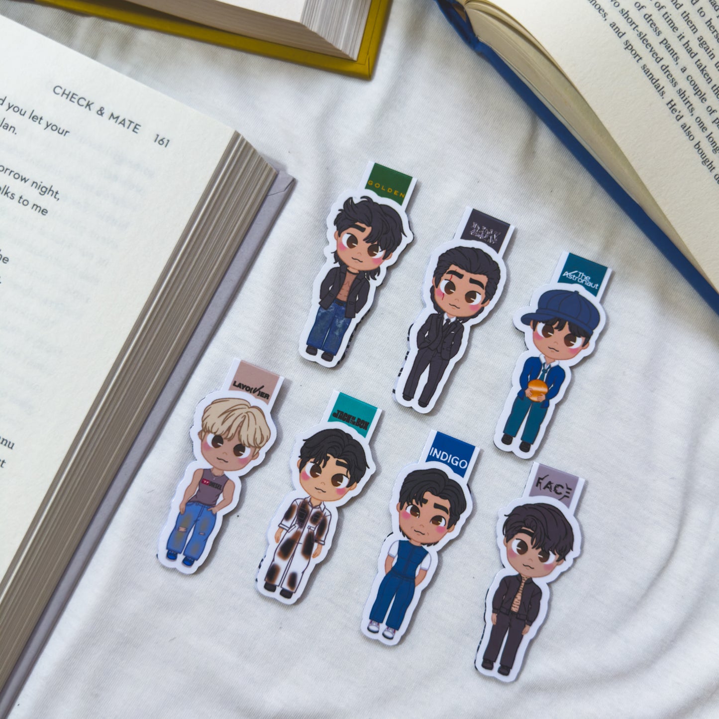 Magnetic bookmarks inspired by BTS, featuring illustrations of RM, Jungkook, Jimin, and the rest of the members with iconic symbols from their music.